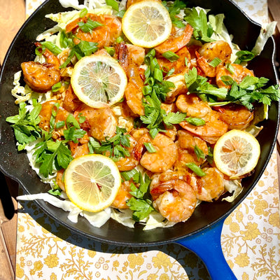 Photo of spicy shrimp with cabbage and lemon in a pan