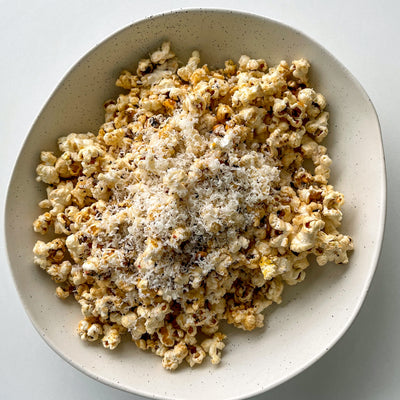 Bowl of spicy popcorn with parmesan cheese sprinkled on top