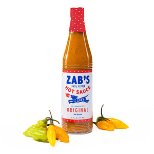 Bottle of Zab's Original sauce with fresh Datil Peppers