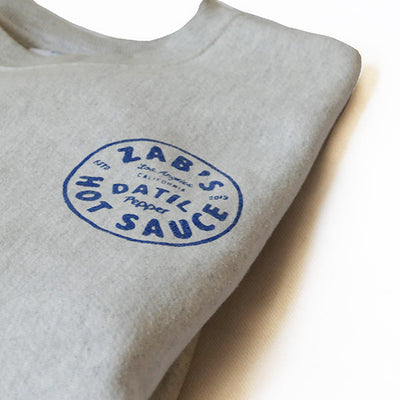 Folded Crew Neck Sweatshirt with Zab’s hot sauce logo in  blue